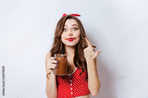 Young model eating chocolate cream