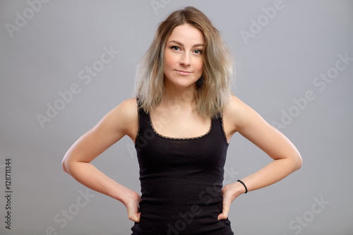 Pretty young woman isolated on gray