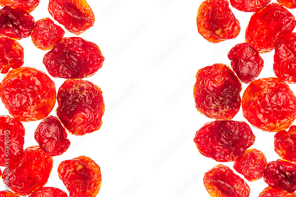 Fototapeta premium Dried cherries closeup on white background. Isolated. Decorative border of glossy red dried cherry. Dried fruit for vegetarian.