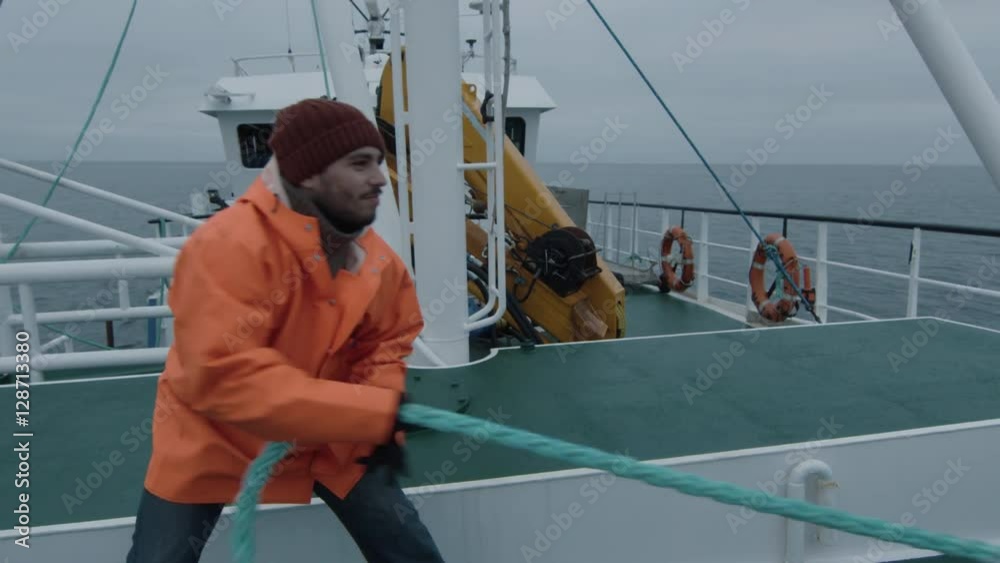 Serious Seaman Pulls the Thick Rope during Traveling on the Ship. Shot ...