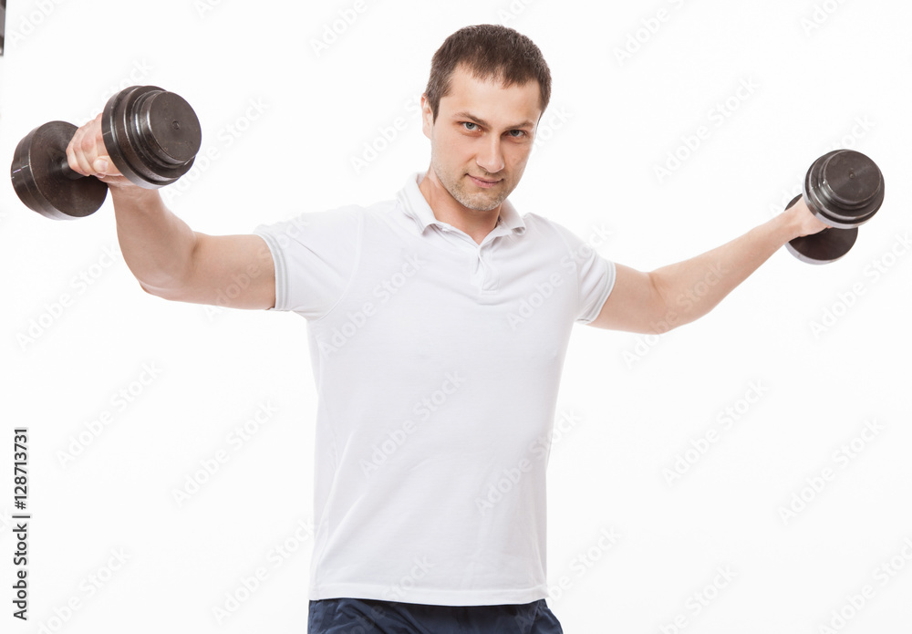 Young man doing exercises with dumbbells Young man doing exercises with dumbbells