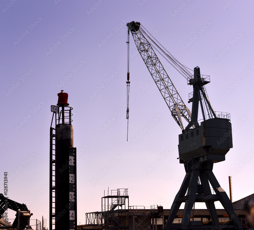 Freight shipping scene with industrial harbor cranes in the sunset. Freight shipping scene with industrial harbor cranes in the sunset.
