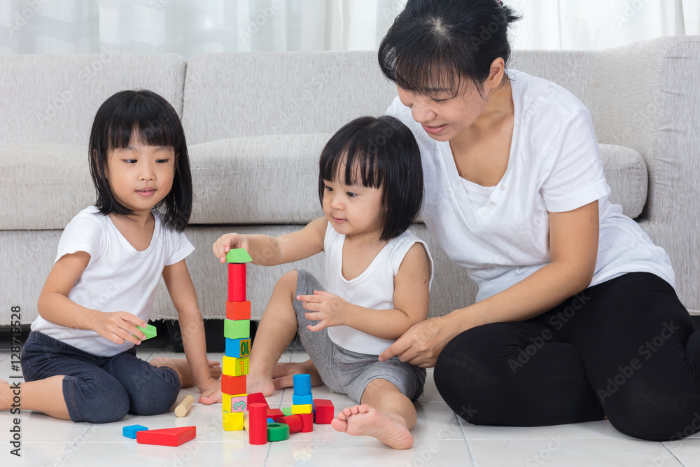 Asian Chinese mother and daughter playing blocks on the floor Asian Chinese mother and daughter playing blocks on the floor