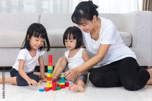 Asian Chinese mother and daughter playing blocks on the floor