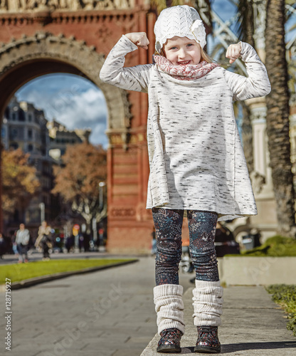 child near Arc de Triomf in Barcelona, Spain showing strength photo