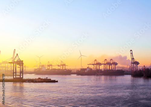 Harbor cranes in the sunset or sundown, freight shipping or container harbor  scene. photo