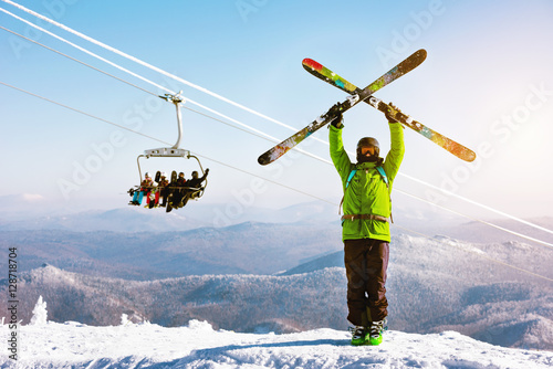 Skies stands ski lift snowboarders backdrop