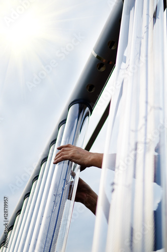 Man installing solar collector tube.