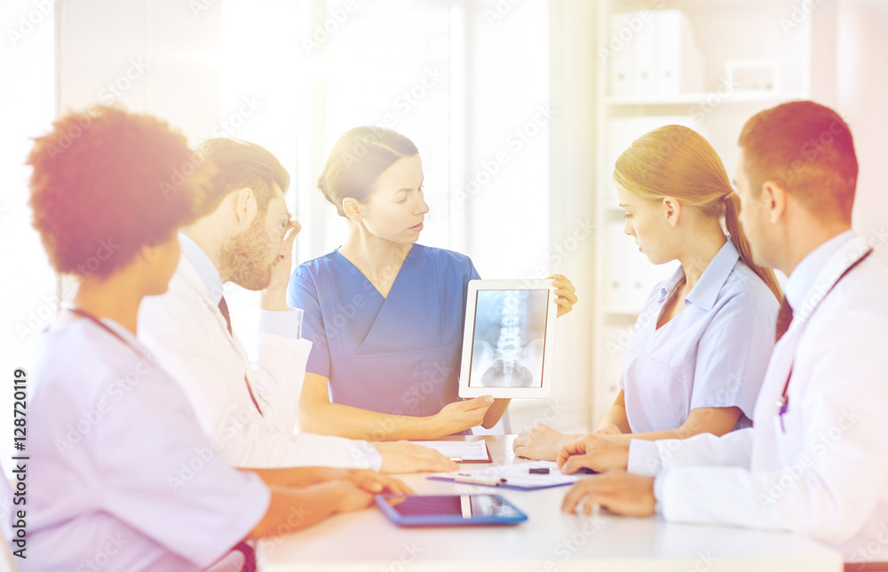 group of doctors with x-ray on tablet pc at clinic group of doctors with x-ray on tablet pc at clinic