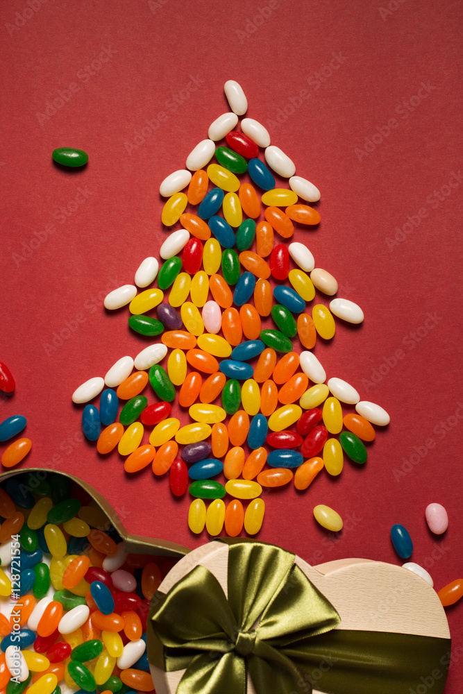 Christmas tree from colorful candies and gift box 
