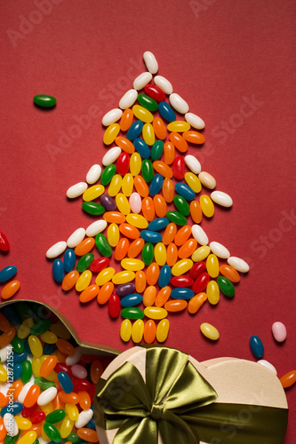 Christmas tree from colorful candies and gift box 