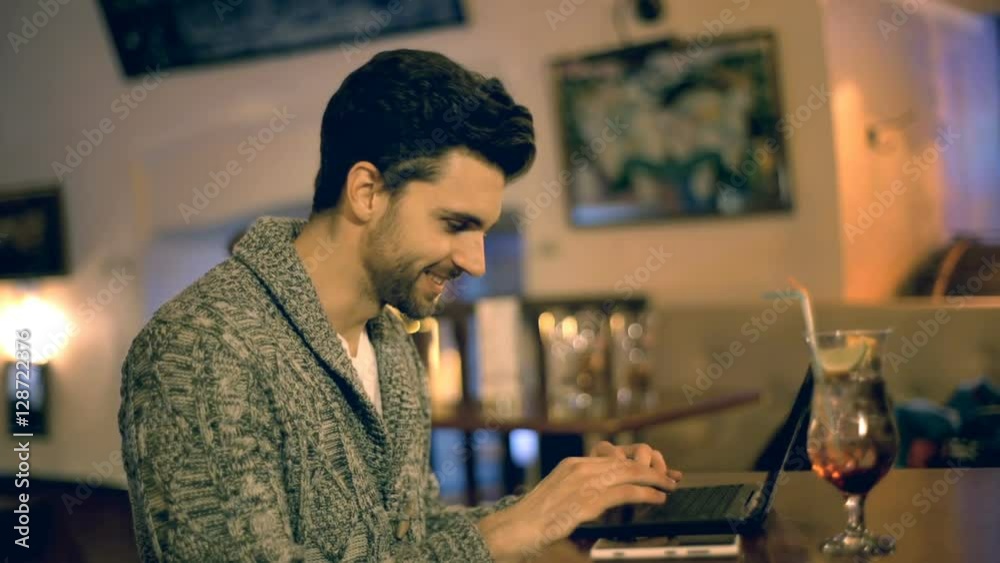 Man receives good news while using laptop in a pub
Man receives good news while using laptop in a pub