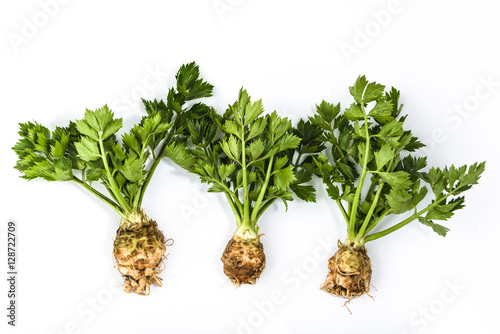 Root of celery with leaves isolated on white, green vegetables