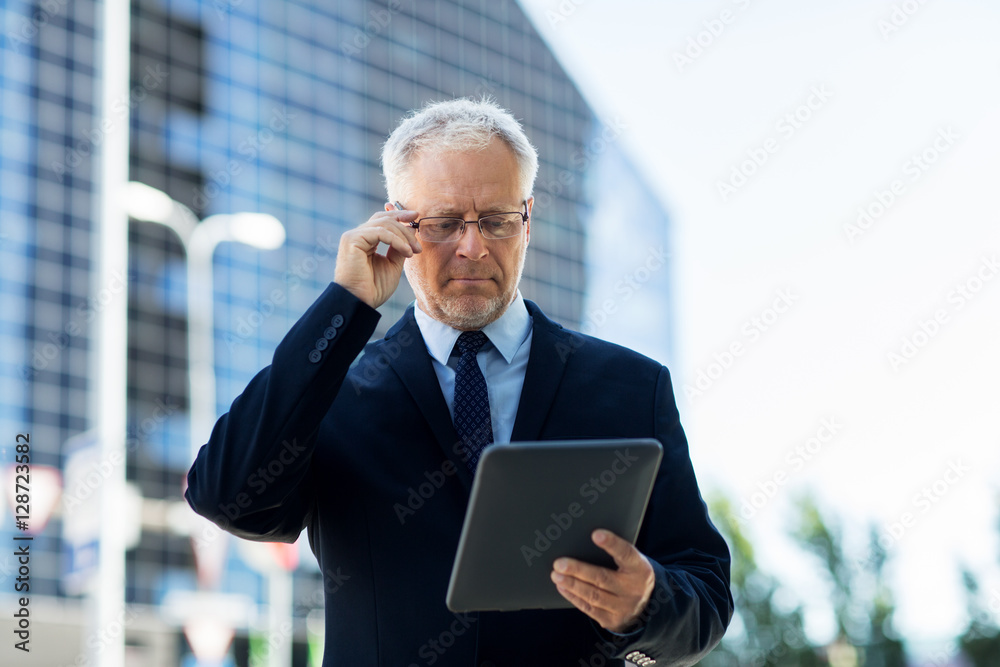 senior businessman with tablet pc on city street senior businessman with tablet pc on city street