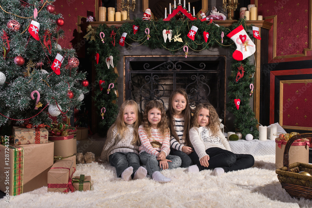 Cute sisters lying on white carpet near christmas tree. Cute sisters lying on white carpet near christmas tree.