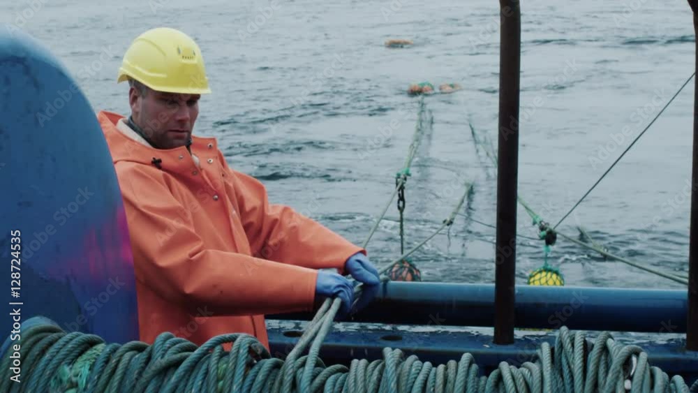  Fisherman Works on Commercial Fishing Ship that Pulls Trawl Net. Shot on RED Cinema Camera in 4K (UHD). 