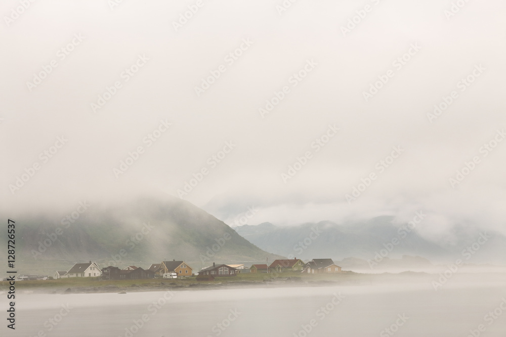 Norway village in clouds of fog. Cloudy Nordic day.