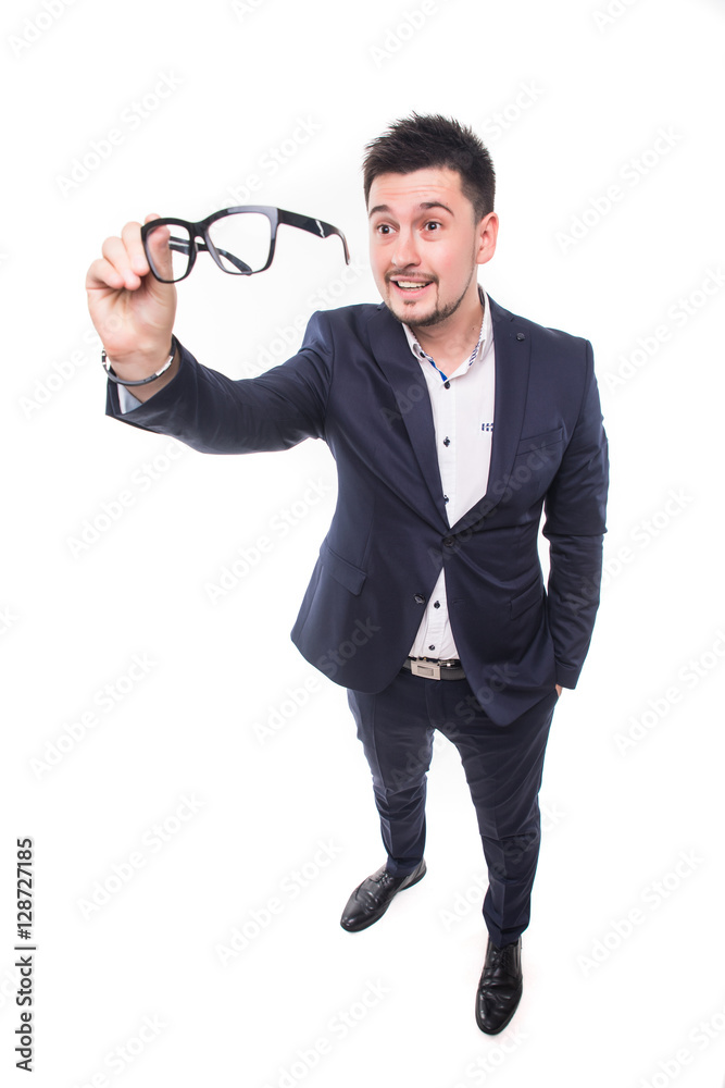 Happy bearded young businessman smiling and looking over glasses Happy bearded young businessman smiling and looking over glasses