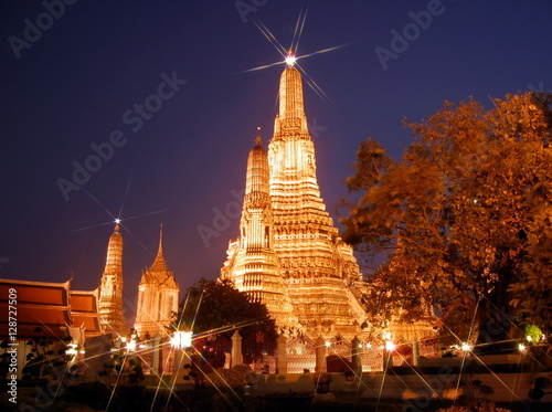 Night view of Wat Arun temple in Bangkok, Thailand. Photo shot with special six-rays efect filter