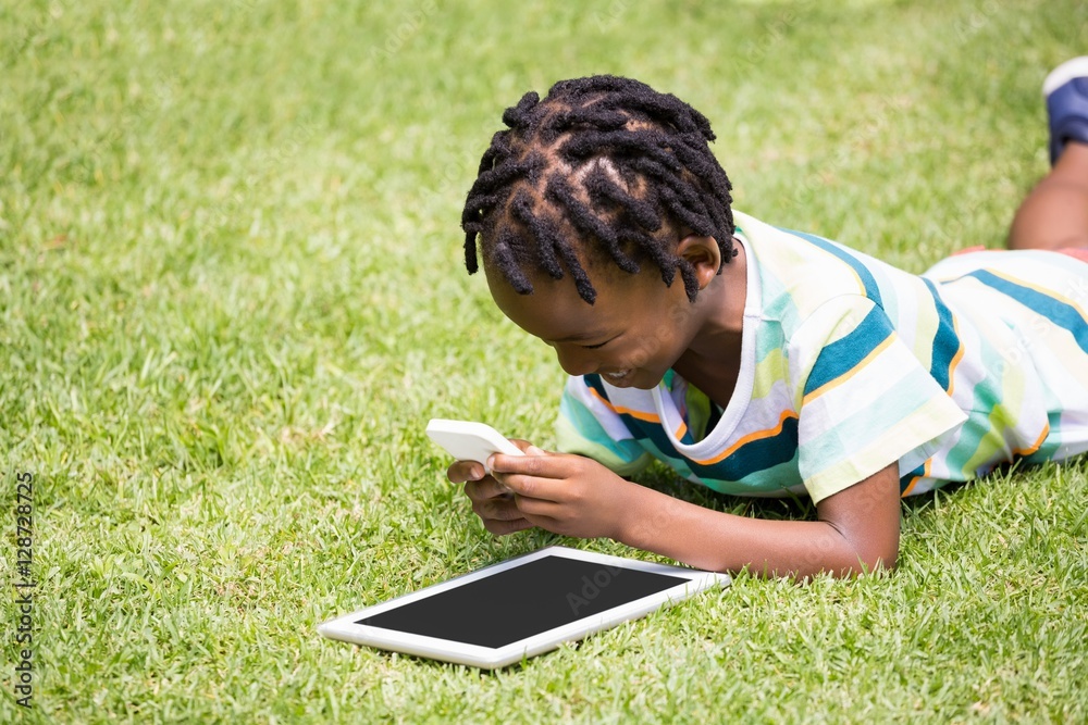 A kid playing with a mobile phone A kid playing with a mobile phone