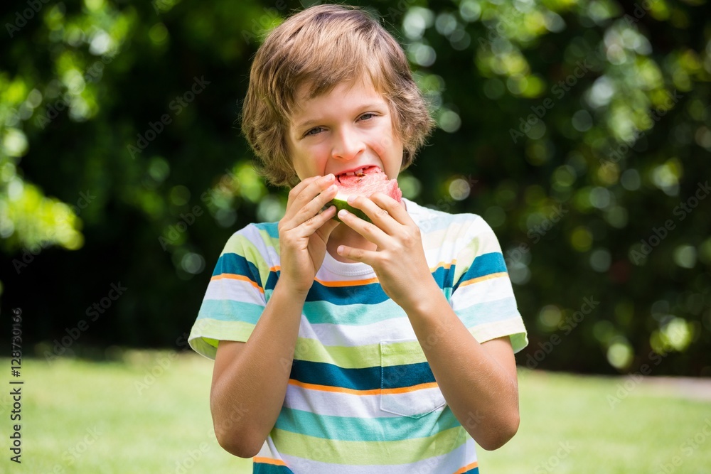 A little boy is eating a watermelon A little boy is eating a watermelon