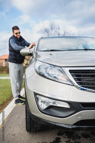 A man cleaning car with microfiber cloth, car detailing (or valeting) concept © hedgehog94