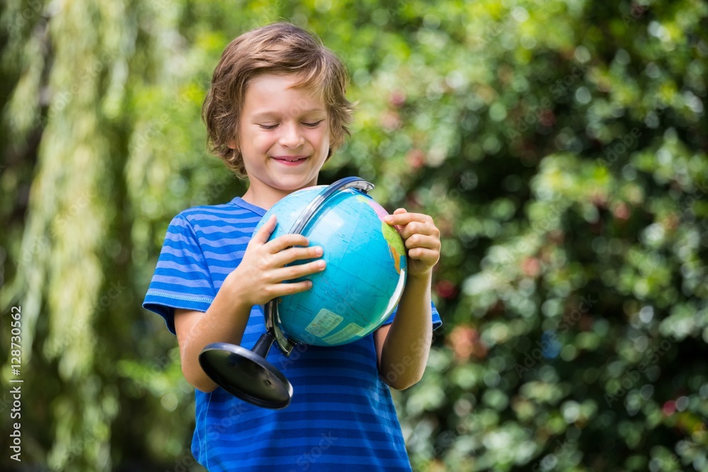 A little boy is holding a globe A little boy is holding a globe