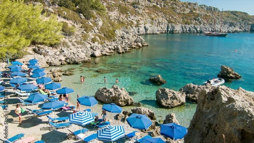 Rhodes Greece Tourists Enjoying Anthony Quinn Bay with Clear Blue Sea Water during a Sunny Day in the Mediterranean Summer Season