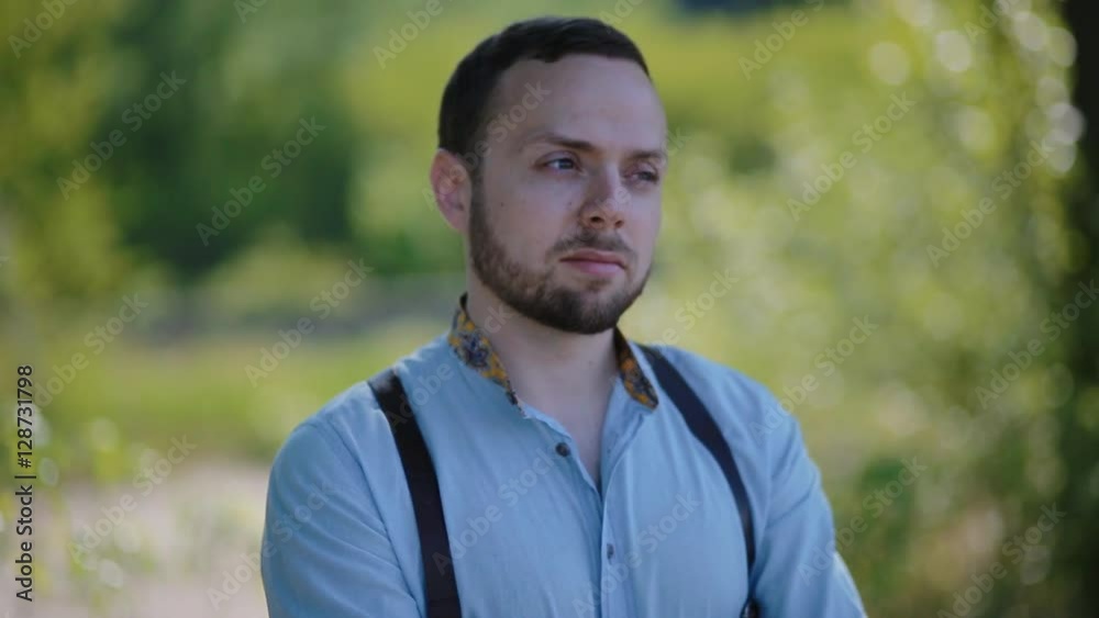 Portrait of young caucasian man. Groom in blue shirt and suspenders. Portrait of young caucasian man. Groom in blue shirt and suspenders.