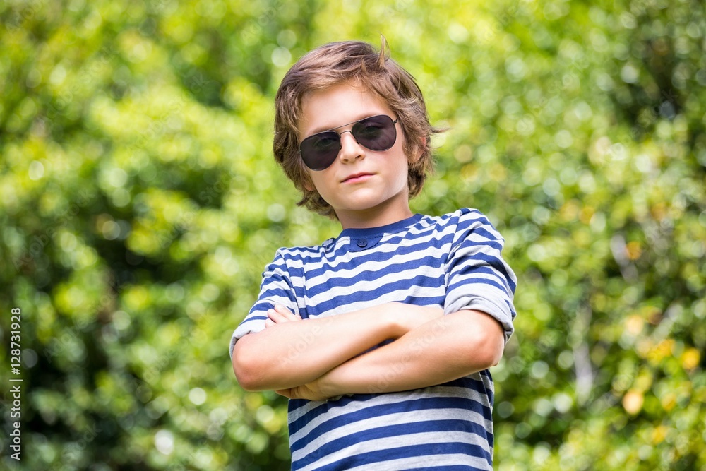 Portrait of cute boy with sunglasses posing with crossed arms Portrait of cute boy with sunglasses posing with crossed arms