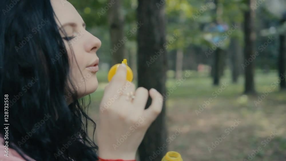girl blowing bubbles outdoors closeup girl blowing bubbles outdoors closeup