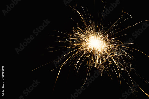 New year party sparkler closeup on black background
