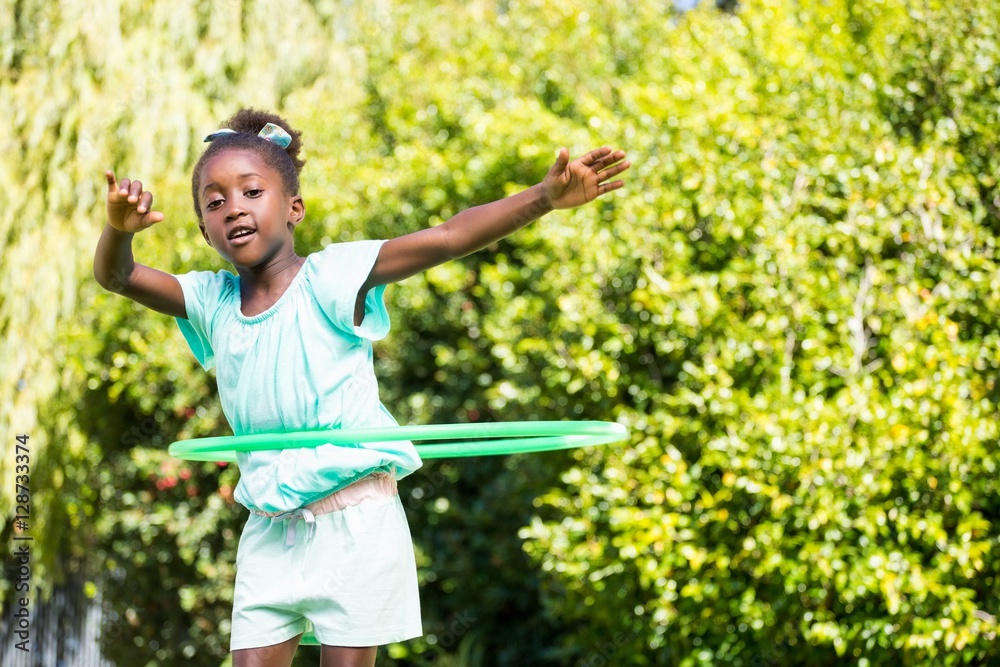 Cute mixed-race girl playing with a hoop Cute mixed-race girl playing with a hoop