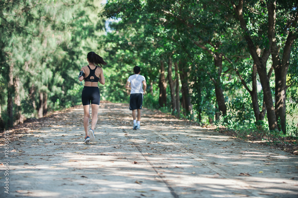 Fototapeta premium Young couple running in the park.