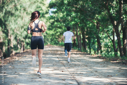 Young couple running in the park.