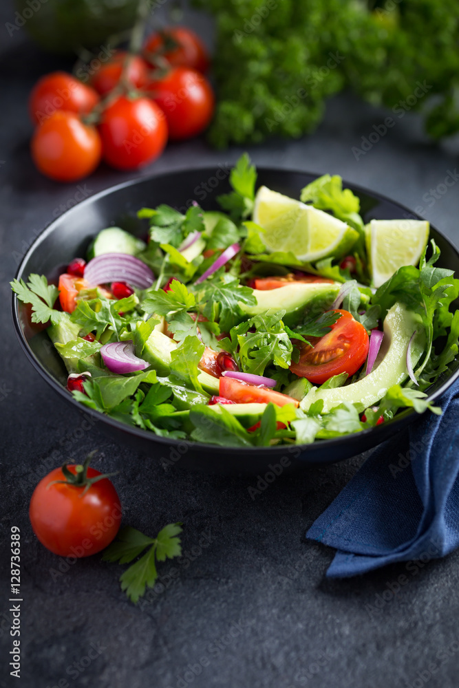 avocado, tomato and arugula salad. Healthy vegan food.