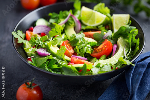 avocado, tomato and arugula salad. Healthy vegan food.