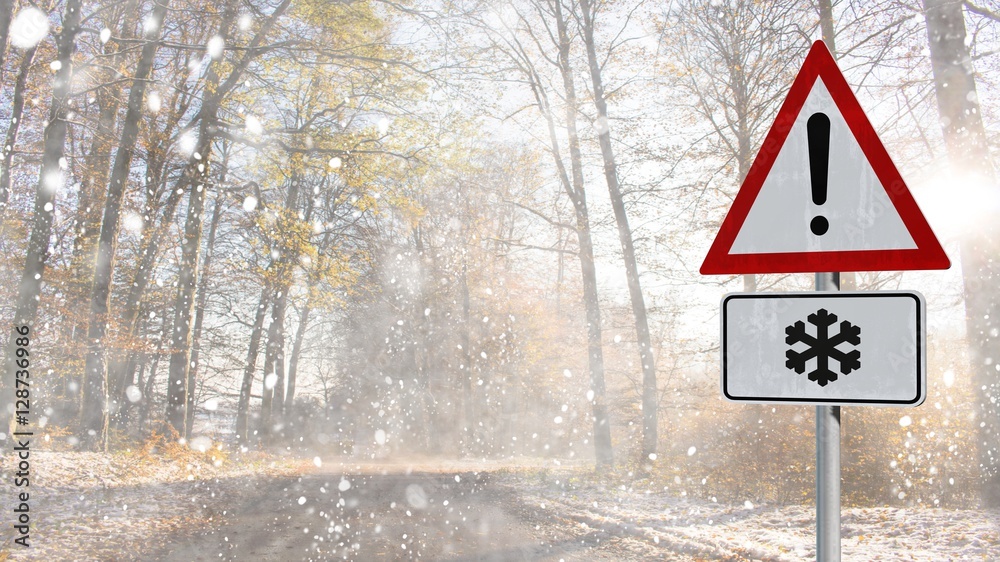 snow warning street sign on a snowy forest road with dark trees and sunbeams on late winter day snow warning street sign on a snowy forest road with dark trees and sunbeams on late winter day