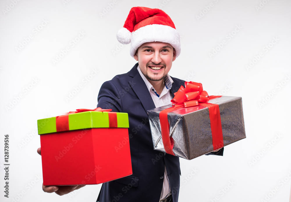 Happy handsome business man in christmas hat with gifts box in hands over white backgrounds Happy handsome business man in christmas hat with gifts box in hands over white backgrounds
