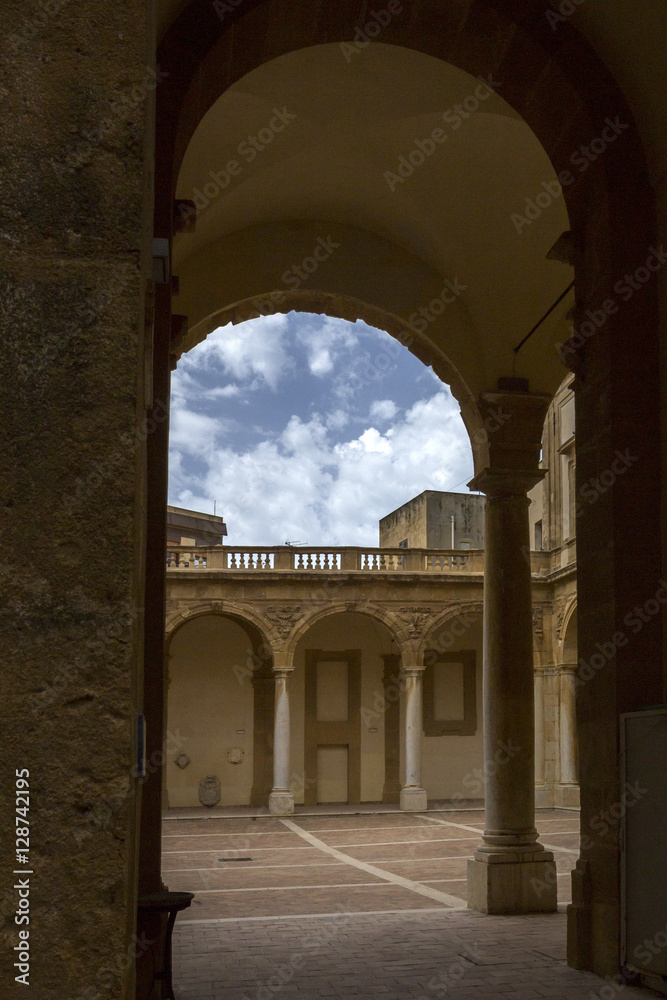 courtyard with arcades and baroque building
