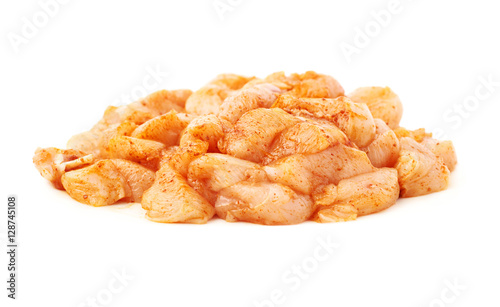 Raw chicken fillet cutted into pieces and spiced isolated over white background