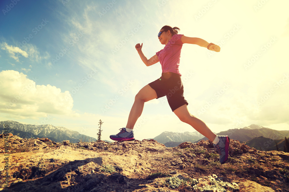 healthy young woman trail runner running on beautiful mountain peak healthy young woman trail runner running on beautiful mountain peak