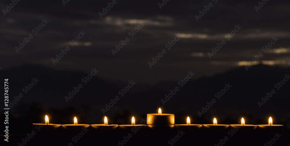 Photo was taken at night using the nine burning decorative candles as foreground for inspiration of Jewish symbols for Hanukkah holiday. Selective focus 