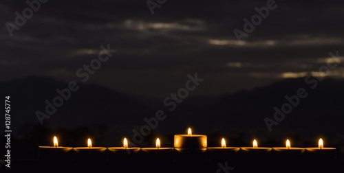 Photo was taken at night using the nine burning decorative candles as foreground for inspiration of Jewish symbols for Hanukkah holiday. Selective focus 