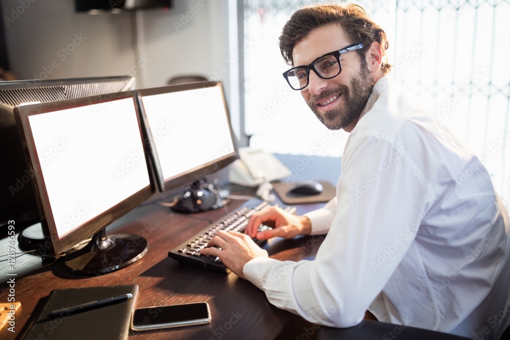 Businessman with glasses smiling and working