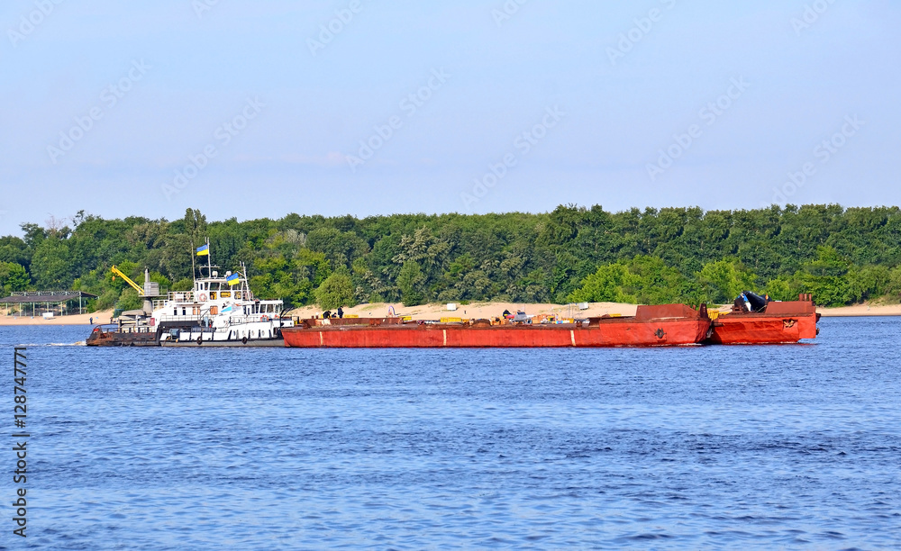 A tugboat assisting a river barge on the Dnieper, Kiev, Ukraine