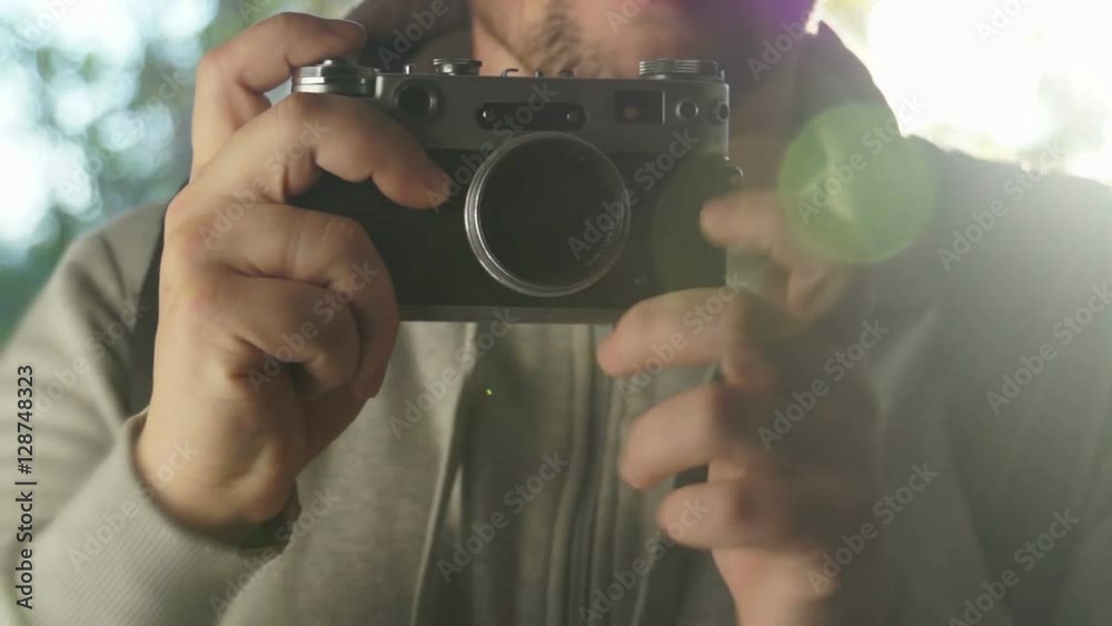 Male tourist holding hands in a retro camera Male tourist holding hands in a retro camera