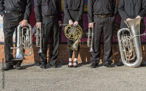 brass instruments lined up on a city street photo