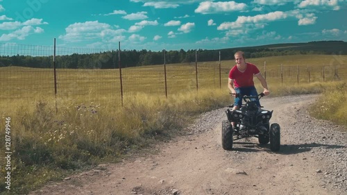 Wallpaper Mural Brave young man rides a an ATV on a field. Torontodigital.ca