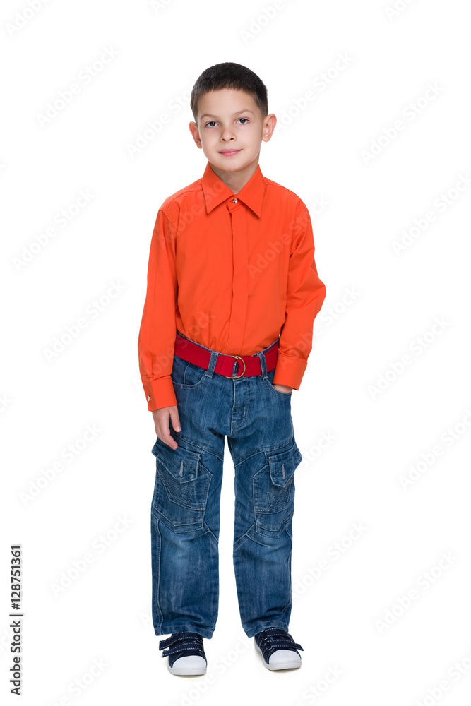 Fototapeta premium Smiling young boy in a red shirt against the white
